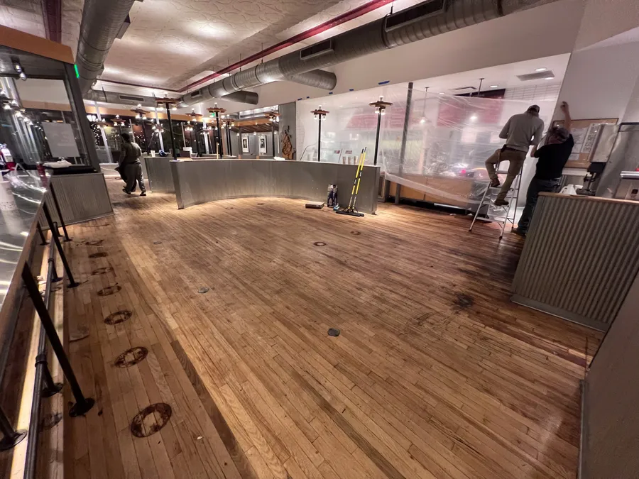 Chipotle common area with prepped wood floor for epoxy